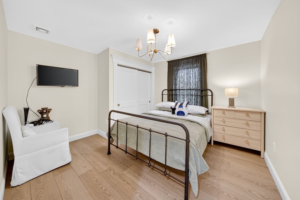 738 Smith Neck Road Dartmouth, MA 02748 - Photo 37 of 42 a bedroom with a bed and a flat screen tv