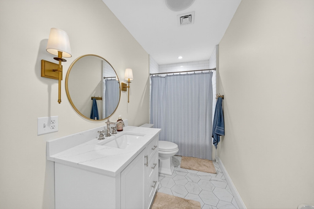 738 Smith Neck Road Dartmouth, MA 02748 - Photo 38 of 42 a bathroom with a sink a toilet and a mirror