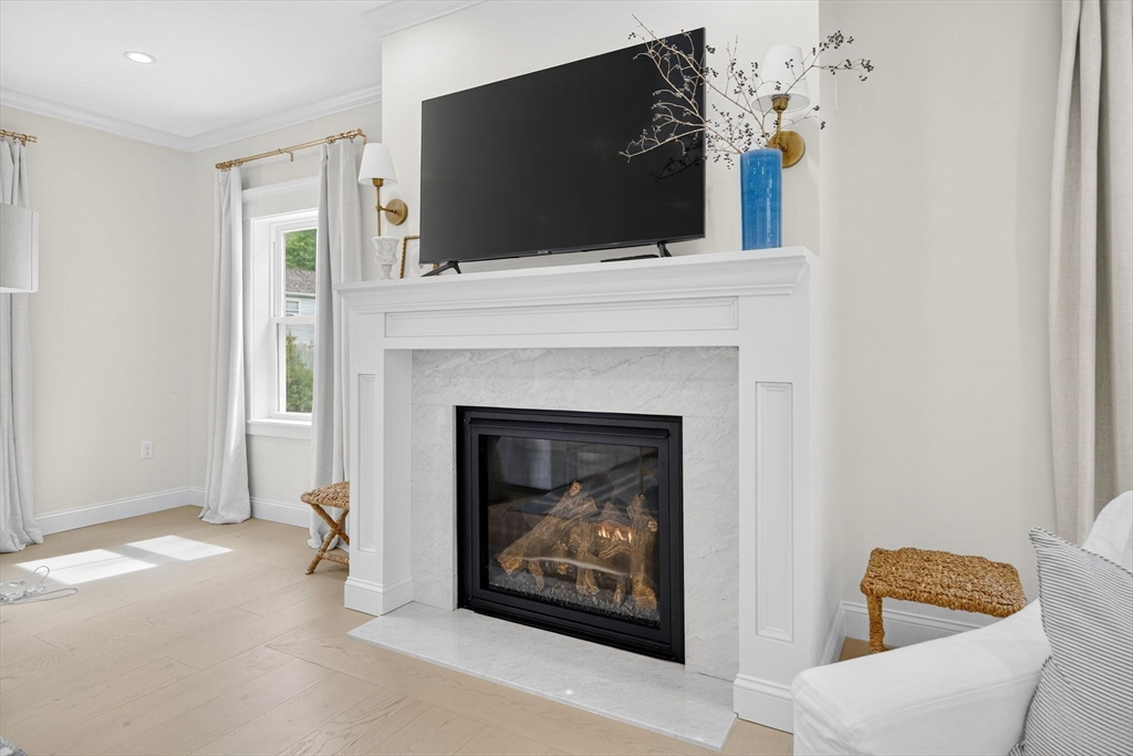 738 Smith Neck Road Dartmouth, MA 02748 - Photo 5 of 42 a living room with a fireplace and a flat screen tv