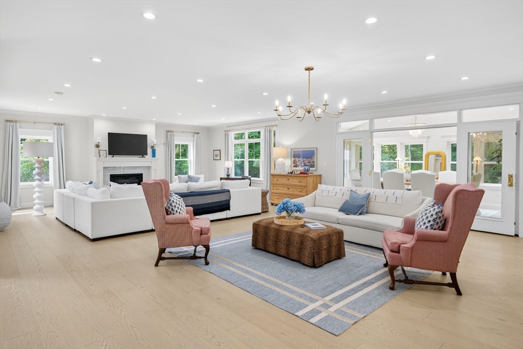 738 Smith Neck Road Dartmouth, MA 02748 - Photo 7 of 42 a living room with furniture and a chandelier