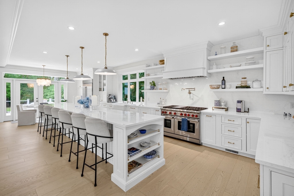 738 Smith Neck Road Dartmouth, MA 02748 - Photo 9 of 42 a kitchen with stainless steel appliances kitchen island granite countertop a stove a sink a dining table and chairs