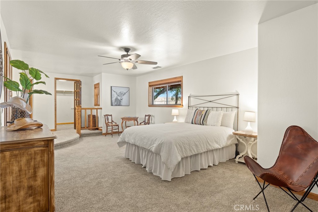 3582 Keefer Road Chico, CA 95973 - Photo 20 of 75 a spacious bedroom with a bed and a chandelier