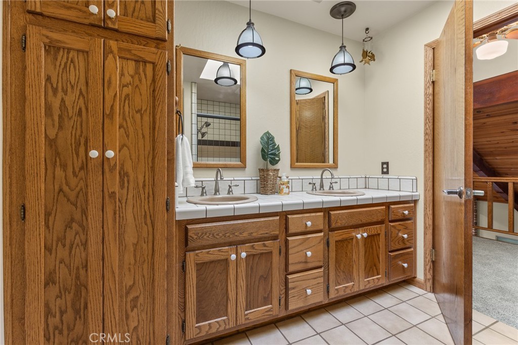 3582 Keefer Road Chico, CA 95973 - Photo 31 of 75 a bathroom with a double vanity sink and a mirror