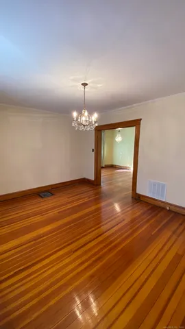 a view of room with wooden floor