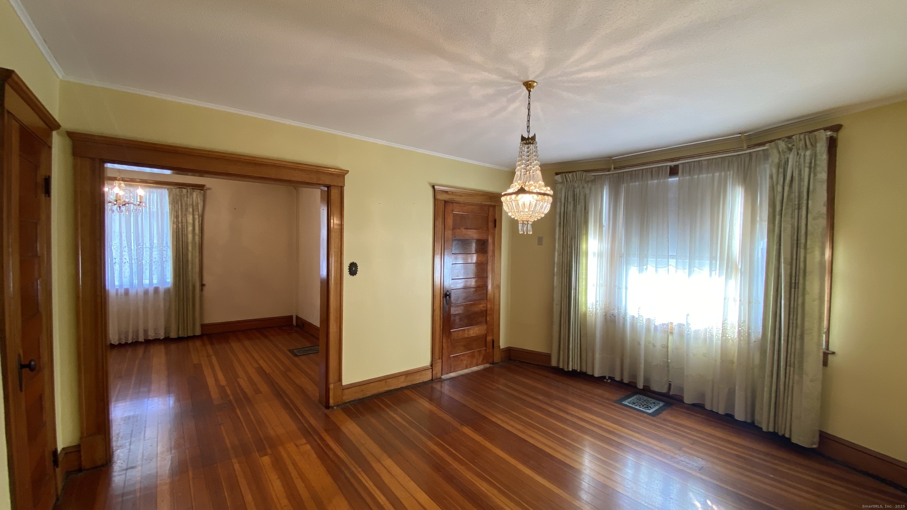 135 Elm Street, Unit 1 Winsted, CT 06098 - Photo 16 of 32 wooden floor in an empty room with a window