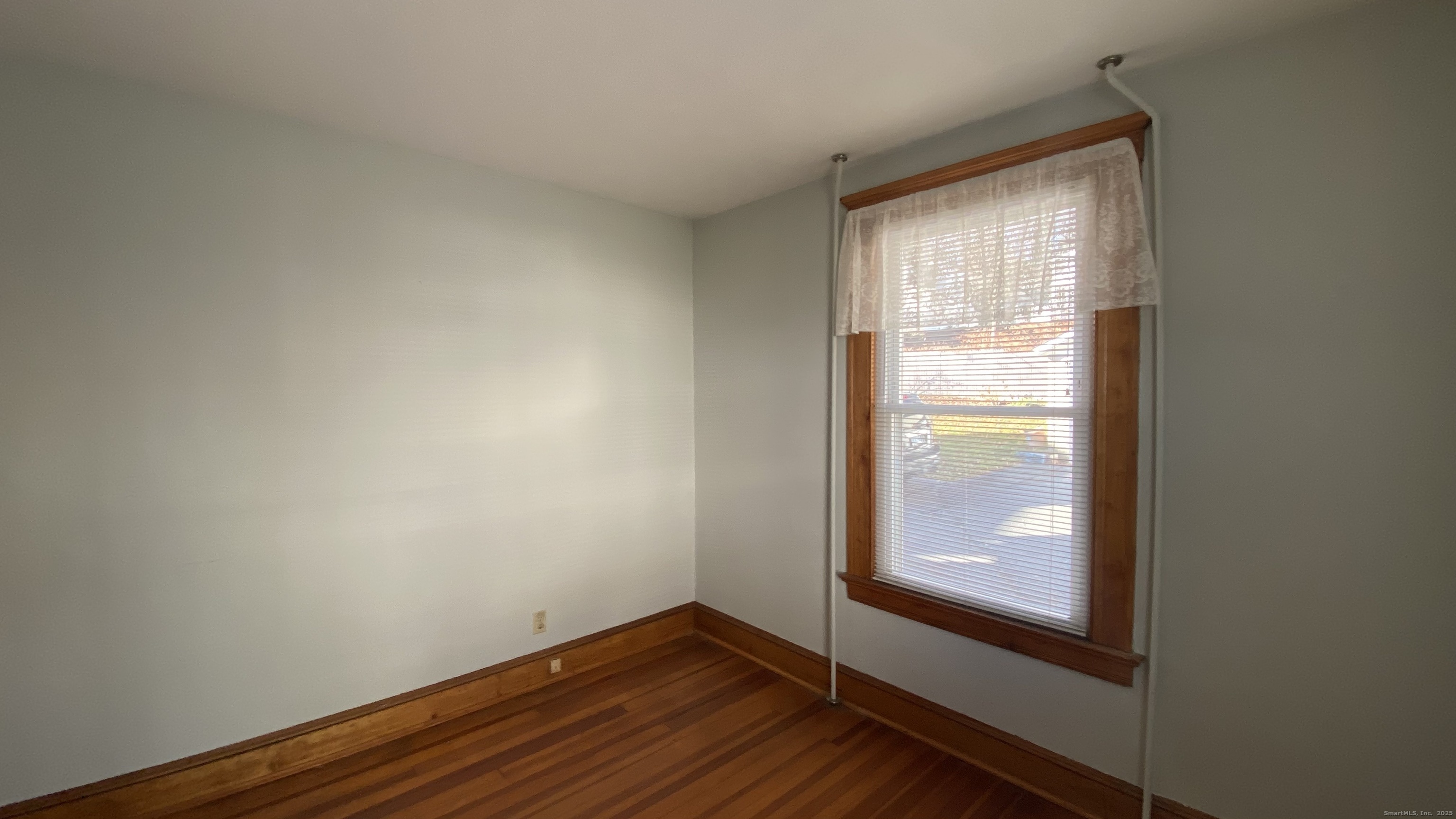 135 Elm Street, Unit 1 Winsted, CT 06098 - Photo 23 of 32 a view of an empty room with wooden floor and a window