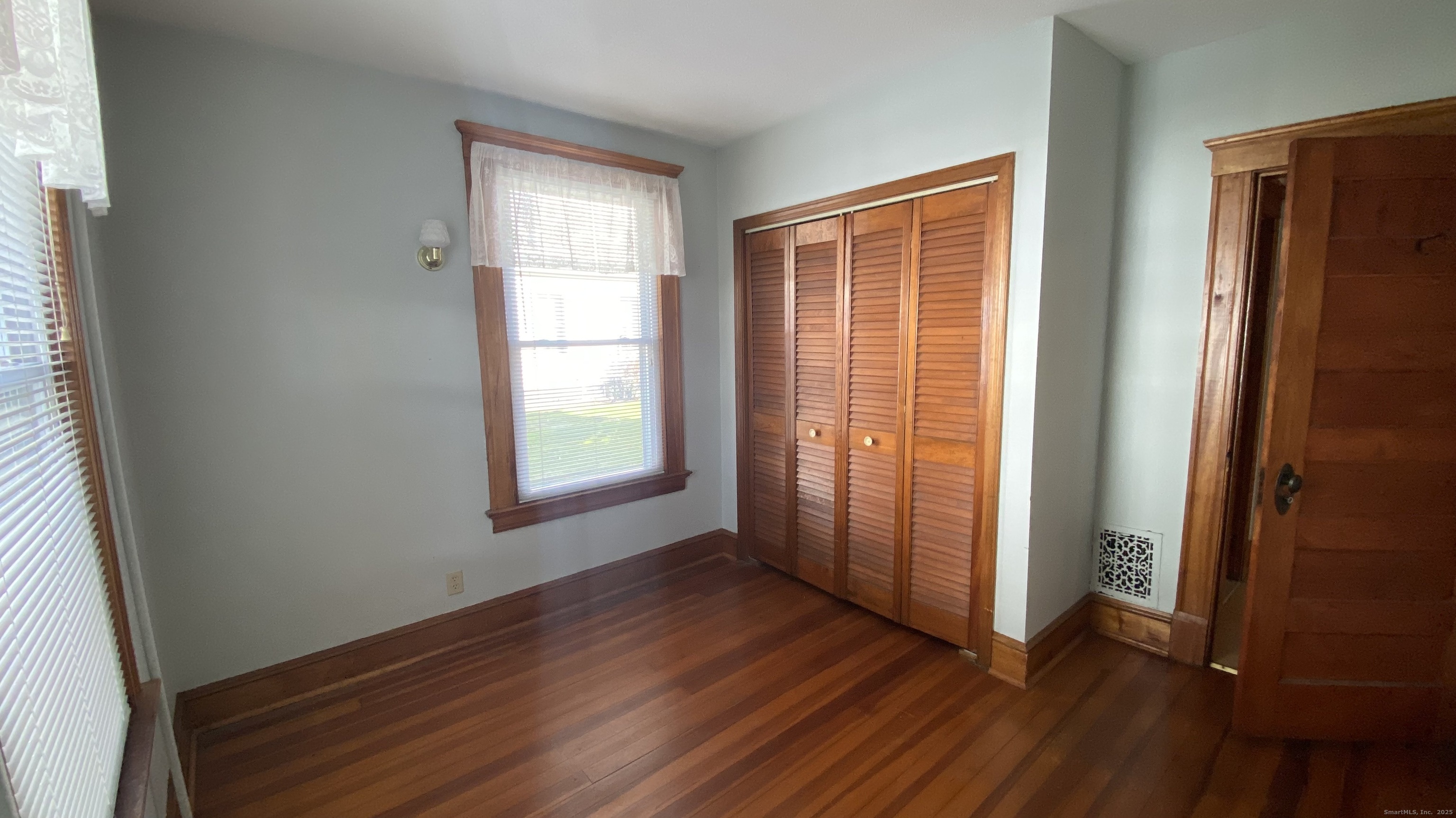 135 Elm Street, Unit 1 Winsted, CT 06098 - Photo 24 of 32 an empty room with wooden floor and windows