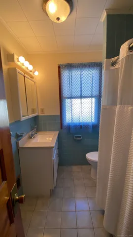 a bathroom with a tub sink and mirror