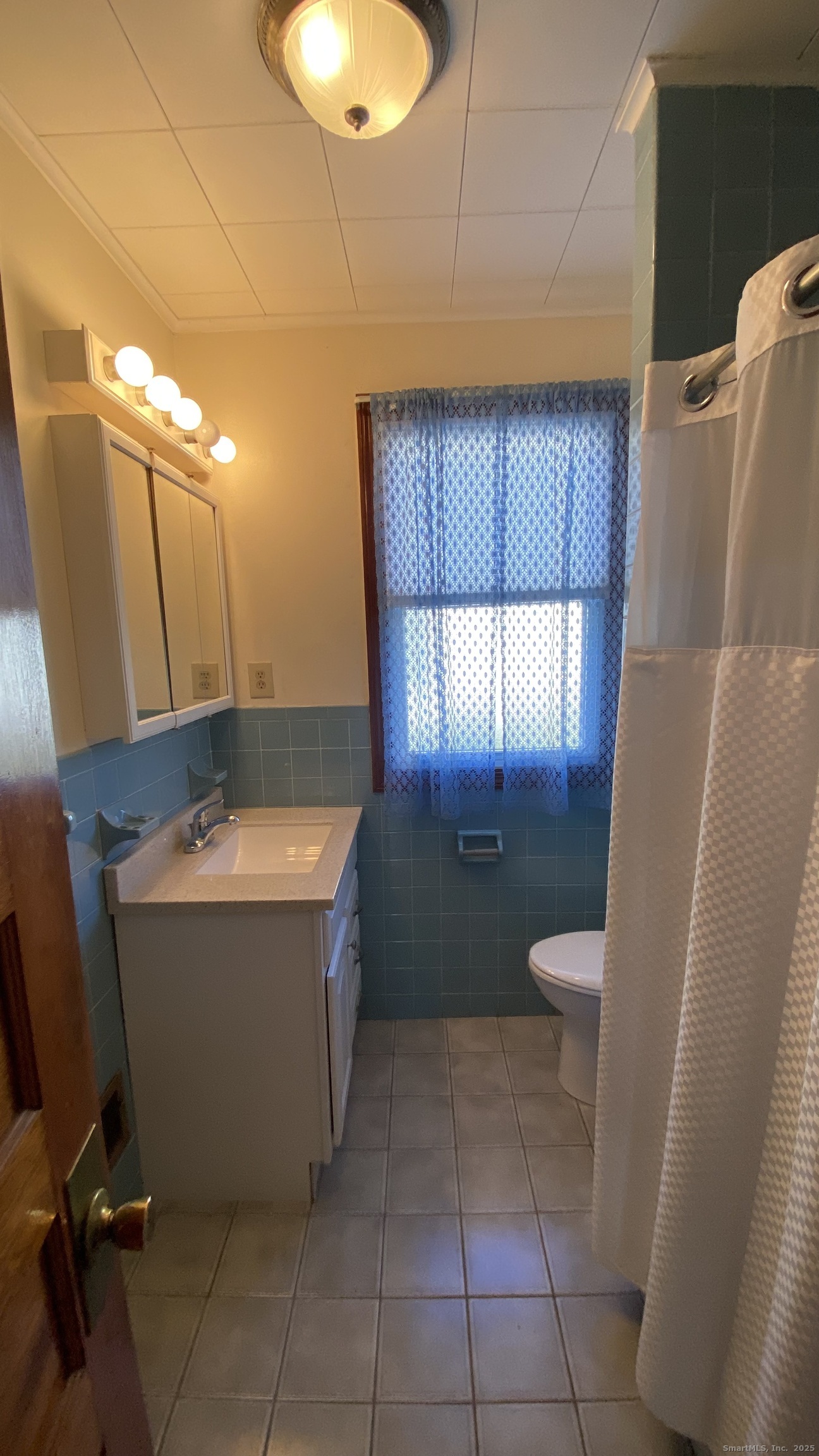 135 Elm Street, Unit 1 Winsted, CT 06098 - Photo 25 of 32 a bathroom with a granite countertop sink and mirror with bathtub