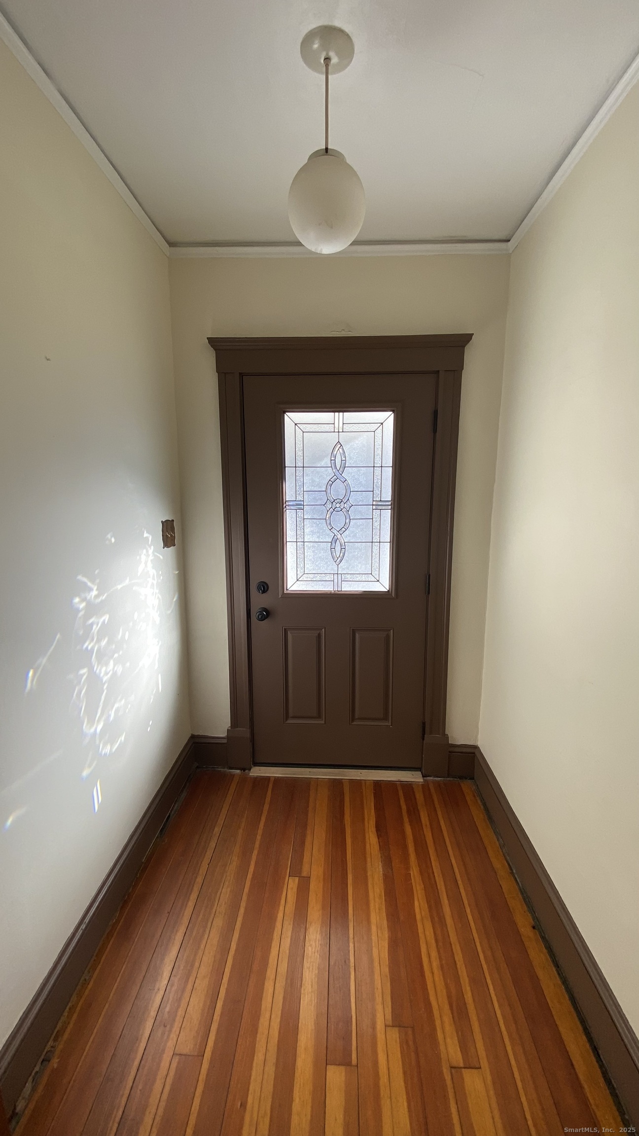 135 Elm Street, Unit 1 Winsted, CT 06098 - Photo 29 of 32 a view of empty room with wooden floor and fan