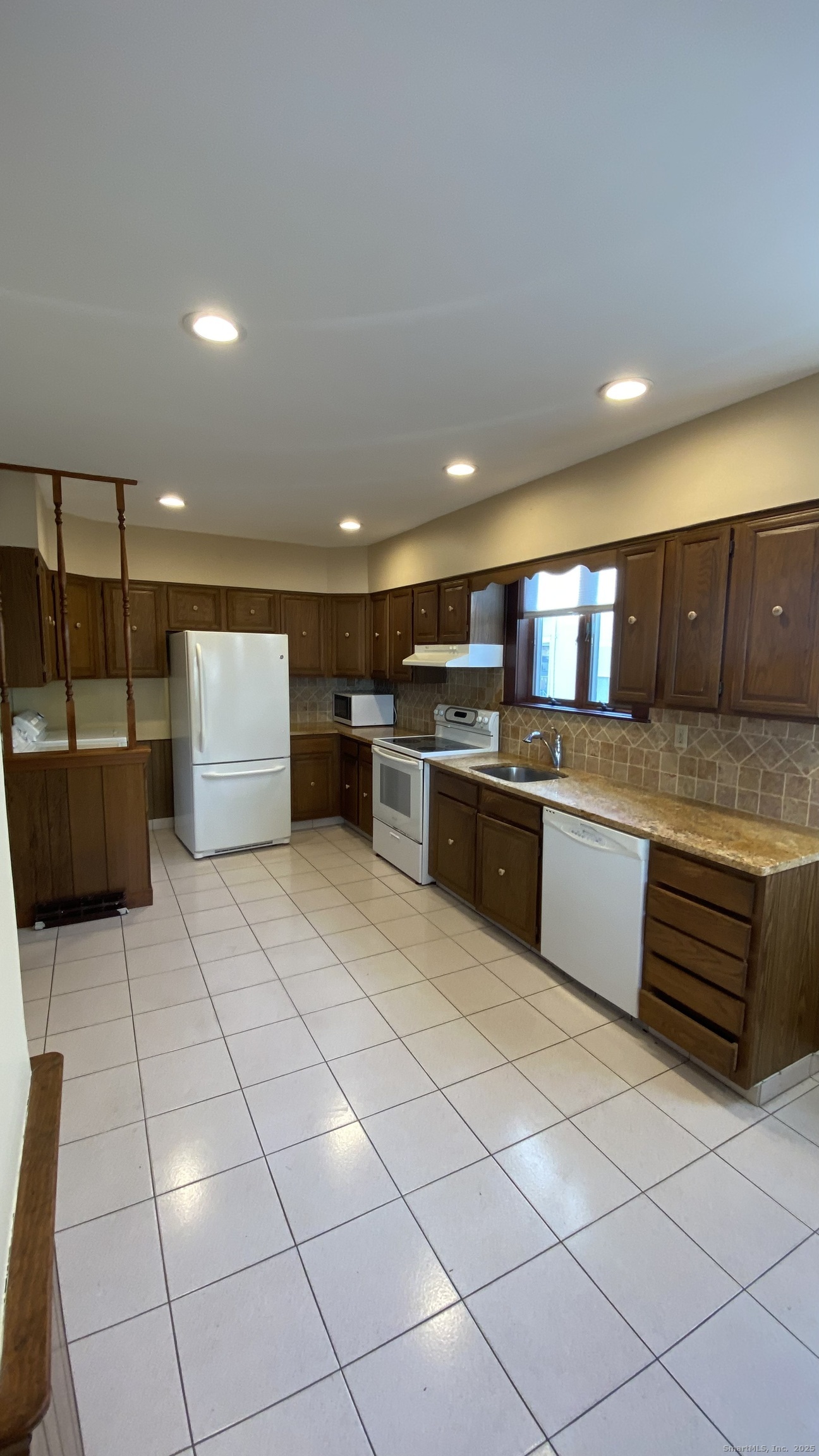 135 Elm Street, Unit 1 Winsted, CT 06098 - Photo 6 of 32 a large kitchen with a large counter top and stainless steel appliances