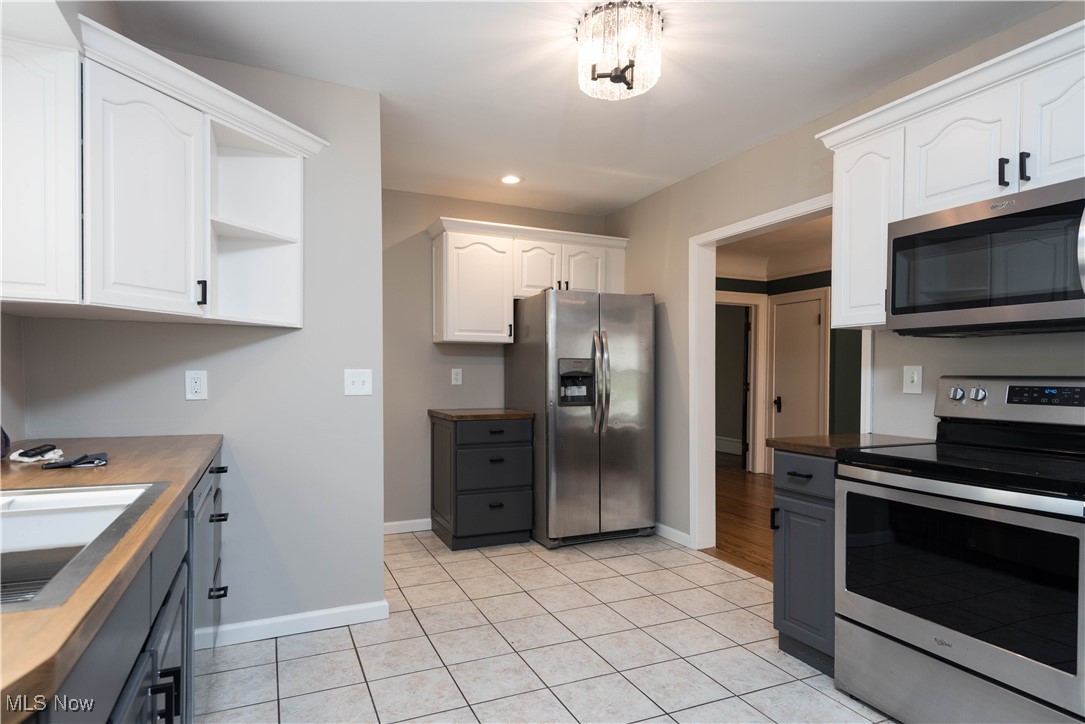7003 Brecksville Road Independence, OH 44131 - Photo 25 of 35 Kitchen with appliances with stainless steel finishes, gray cabinets, white cabinetry, light tile patterned flooring, and recessed lighting