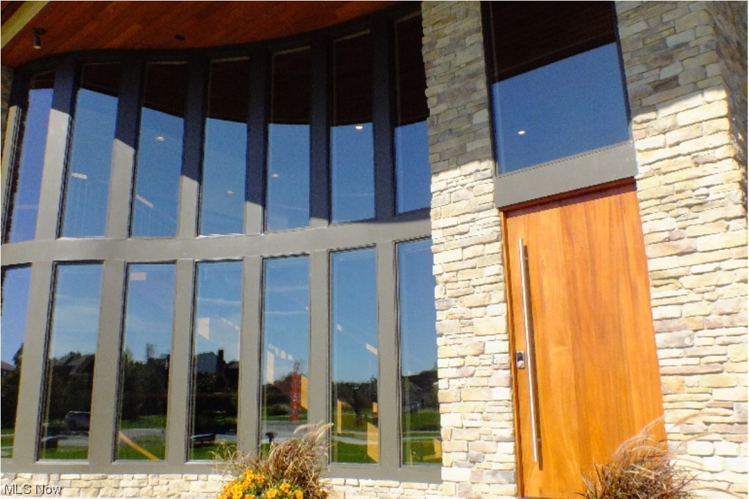 2300 Rivers Edge Drive Willoughby, OH 44094 - Photo 2 of 29 THe front entrance greets you with this curved walll of windows & massive wooden door