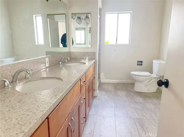 a bathroom with a glass shower door and a toilet
