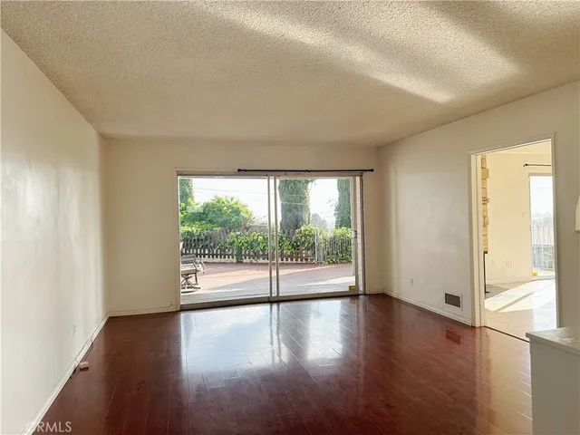 a view of wooden floor and windows in a room