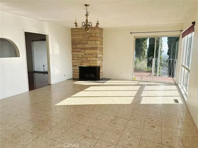 a view of kitchen with granite countertop sink and refrigerator