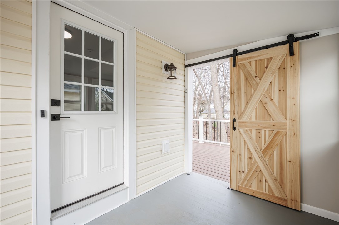 260 Point Pleasant Road Irondequoit, NY 14622 - Photo 9 of 49 Enclosed porch with sliding barn door to deck