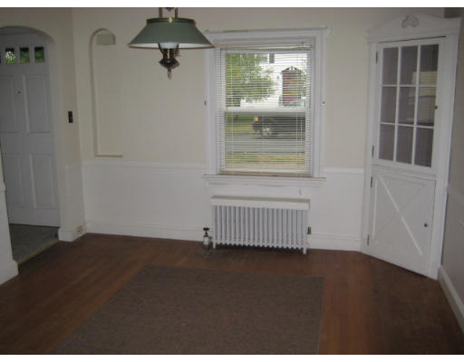 194 Dayton Street Springfield, MA 01118 - Photo 6 of 20 an empty room with wooden floor and windows