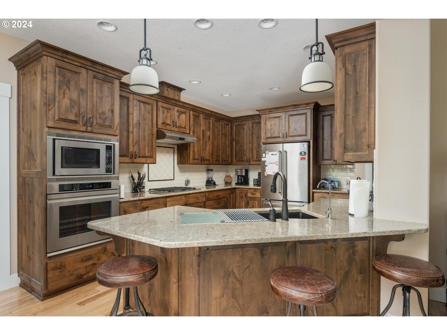 8225 Northeast Dog Ridge Road Newberg, OR 97132 - Photo 11 of 48 a kitchen with kitchen island granite countertop a sink cabinets and stainless steel appliances