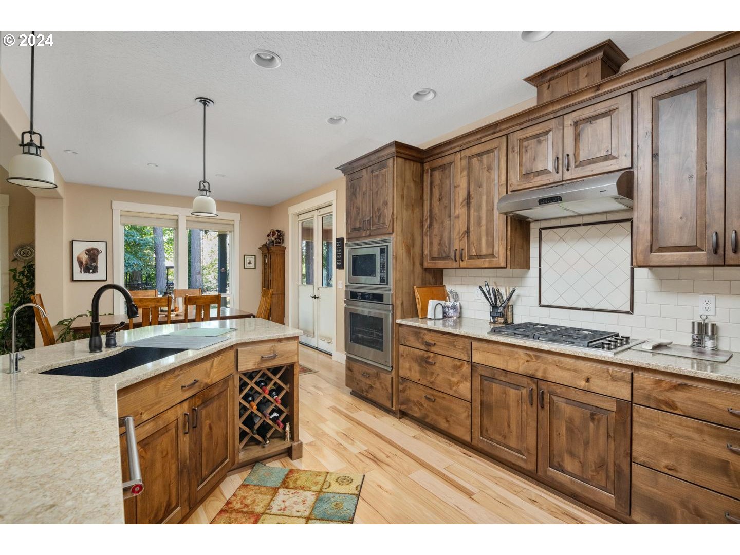 8225 Northeast Dog Ridge Road Newberg, OR 97132 - Photo 13 of 48 a kitchen with stainless steel appliances granite countertop a sink stove and cabinets