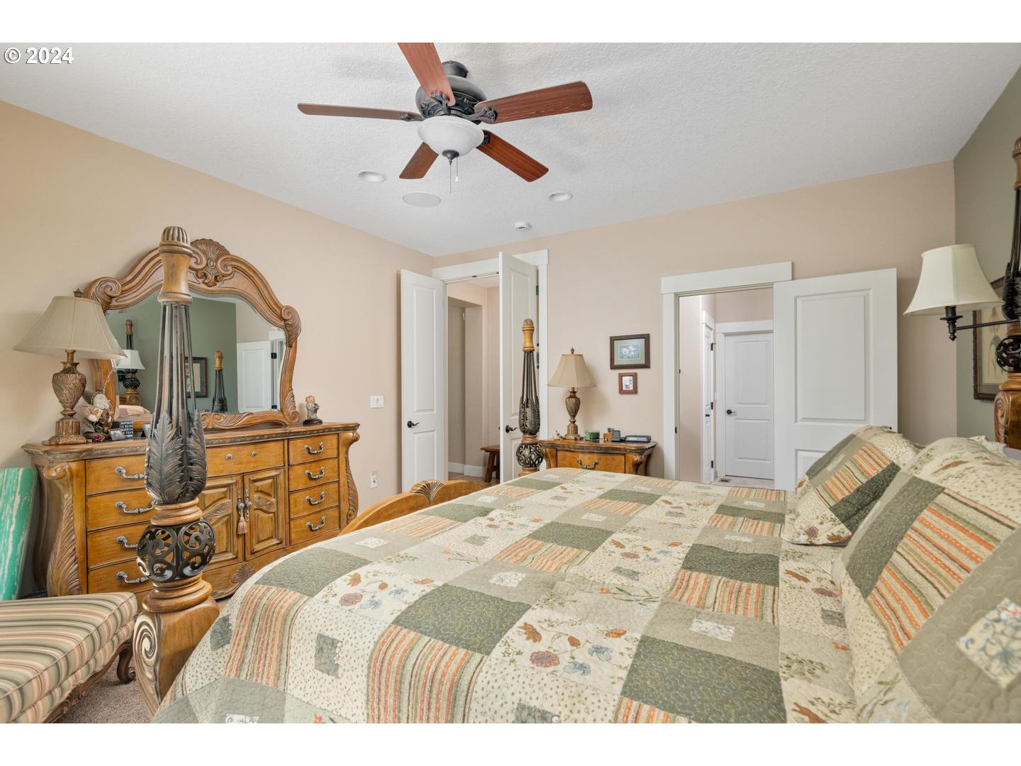 8225 Northeast Dog Ridge Road Newberg, OR 97132 - Photo 16 of 48 a bedroom with a bed a dresser and potted plants with the wooden floor