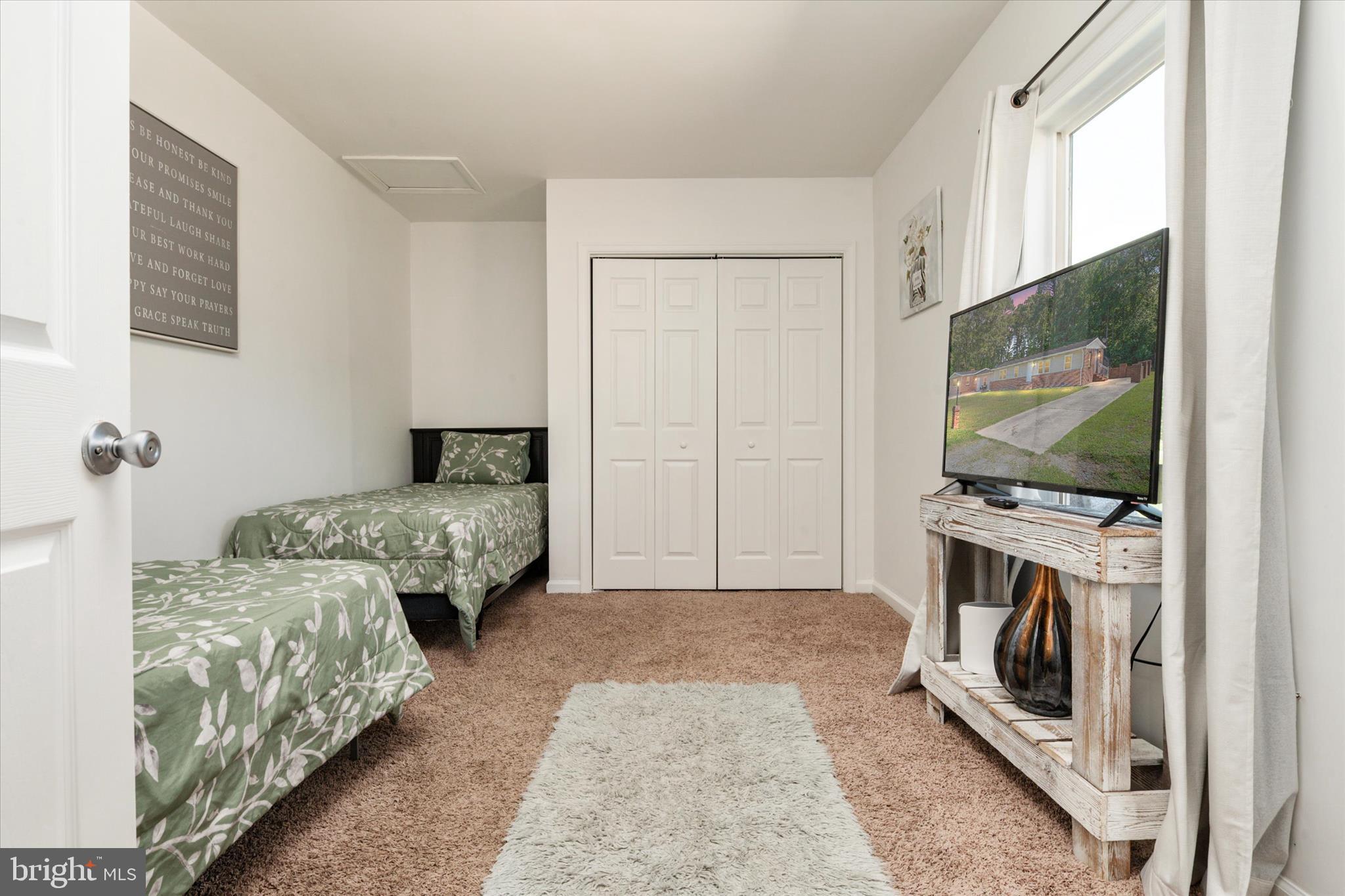 108 Wilson Road Grasonville, MD 21658 - Photo 24 of 38 a bedroom with a bed and a flat screen tv