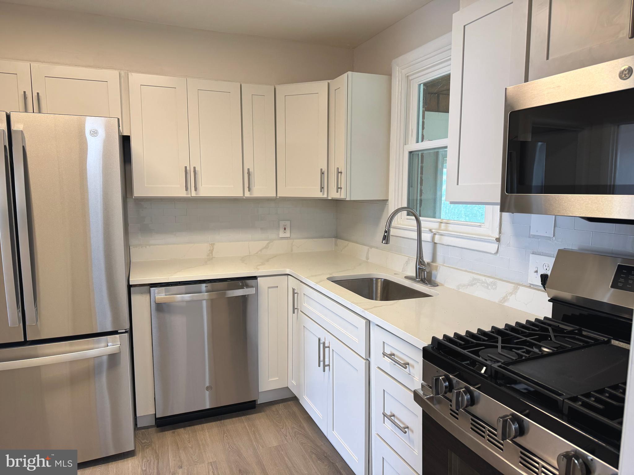 609 Wallerson Road Baltimore, MD 21228 - Photo 8 of 15 a kitchen with a sink stove and refrigerator