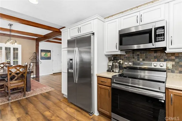 a kitchen with stainless steel appliances a stove a microwave and a refrigerator