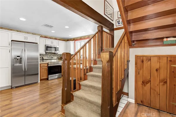 a view of a kitchen with an entryway and wooden floor