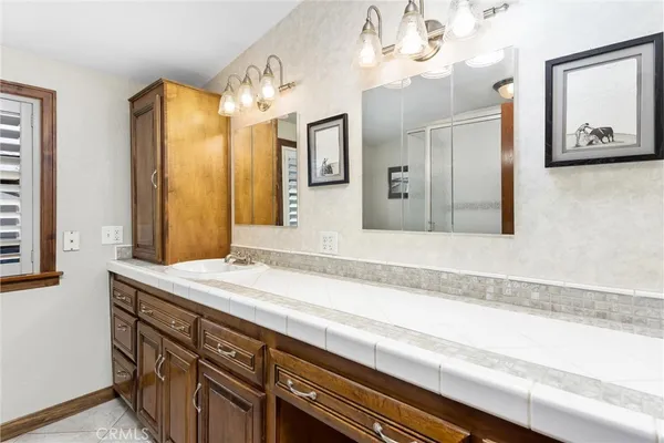 a bathroom with a sink a vanity and a large mirror