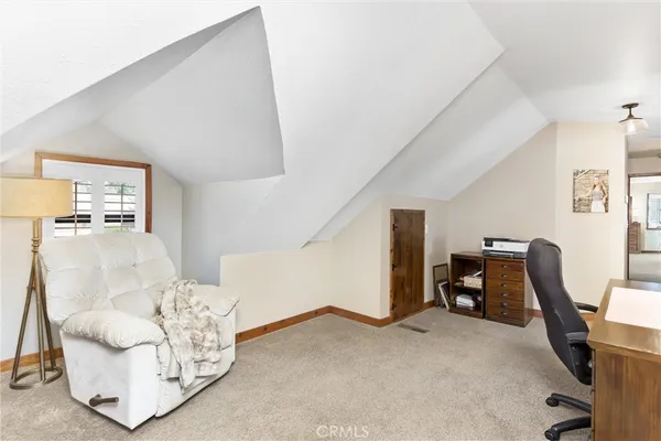 a view of livingroom with furniture and workspace