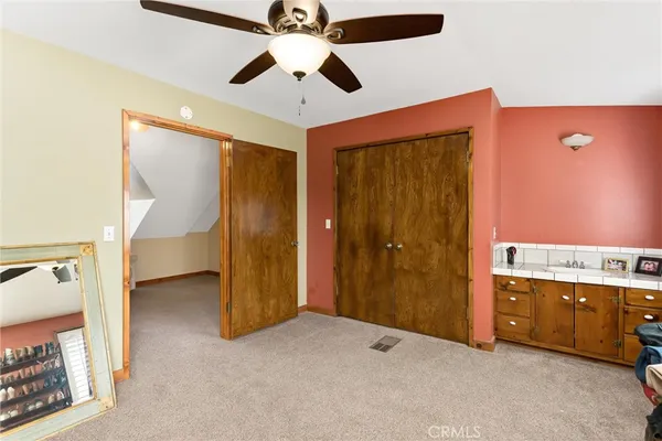 wooden floor and chandelier fan in a room