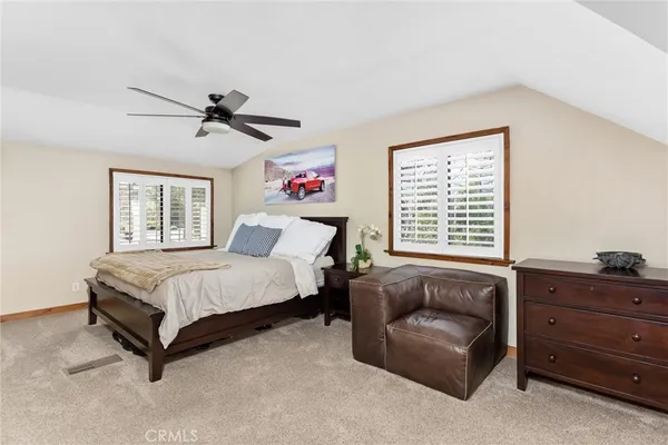 a spacious bedroom with a bed a couch and a window
