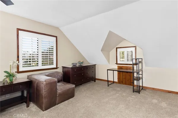 a spacious bedroom with a bed and a window