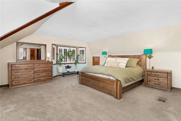 a spacious bedroom with a bed and furniture
