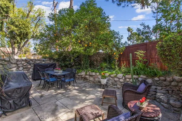a backyard of a house with outdoor seating