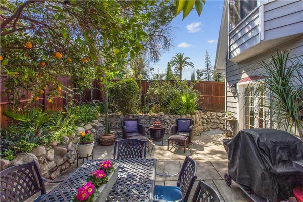 a view of a patio with couches and potted plants