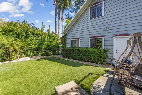 a view of a backyard with plants and a patio