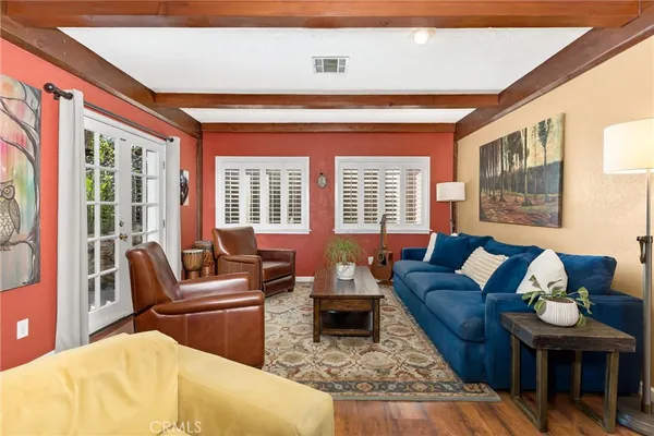a living room with furniture and a floor to ceiling window