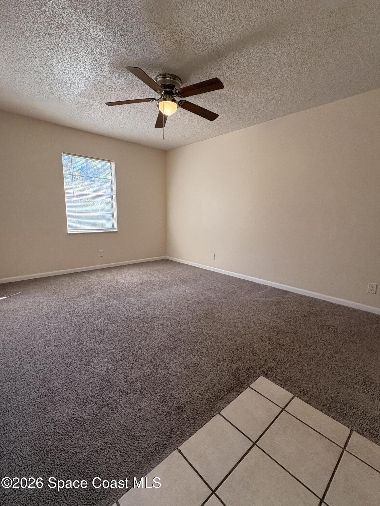 2000 Agora Circle Southeast, Unit 201 Palm Bay, FL 32909 - Photo 3 of 10 an empty room with a ceiling fan and window
