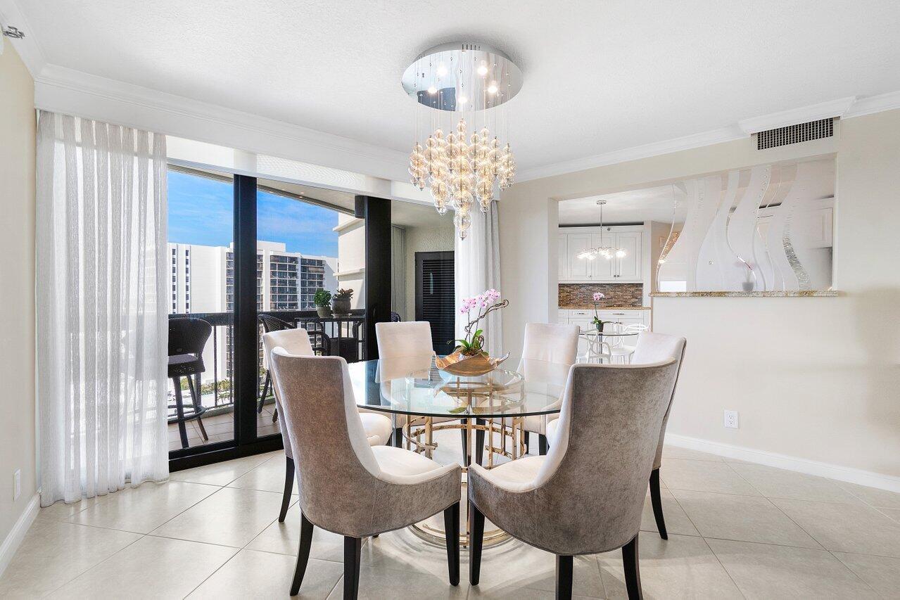 4545 North Ocean Boulevard, Unit 11C Boca Raton, FL 33431 - Photo 15 of 58 a dining room with furniture a chandelier and window