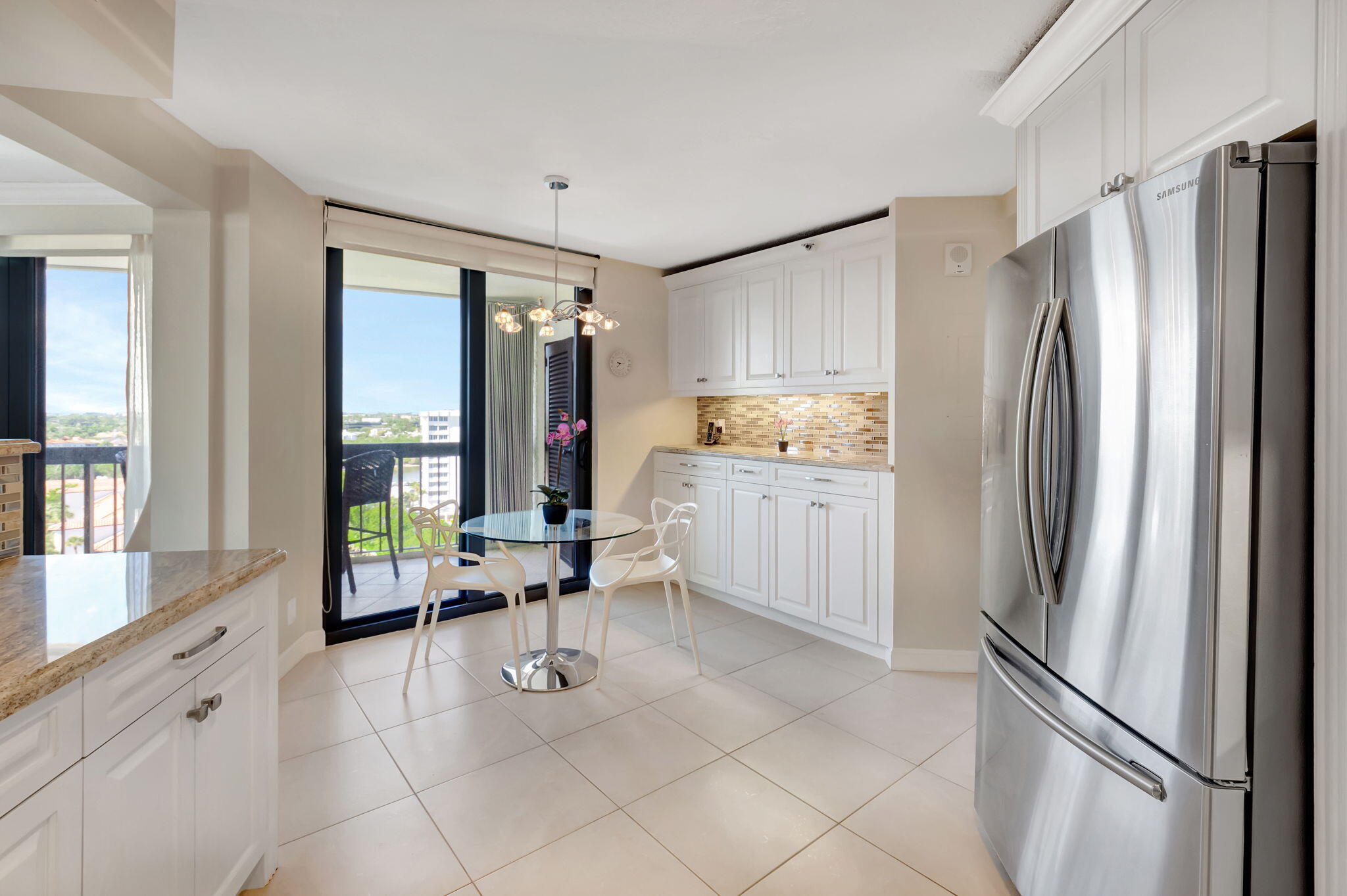 4545 North Ocean Boulevard, Unit 11C Boca Raton, FL 33431 - Photo 23 of 58 a kitchen with stainless steel appliances a refrigerator sink and window