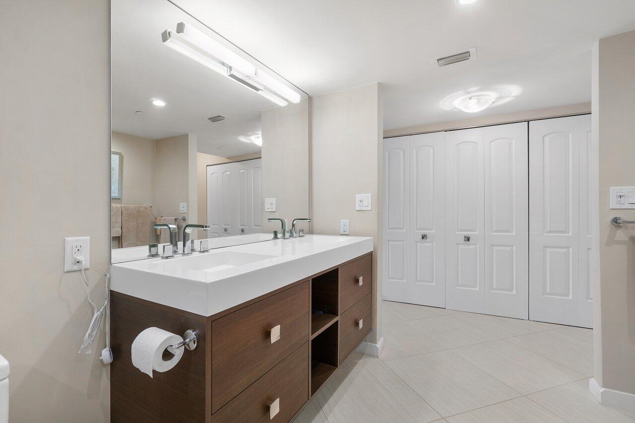 4545 North Ocean Boulevard, Unit 11C Boca Raton, FL 33431 - Photo 35 of 58 a bathroom with a double vanity sink a and mirror