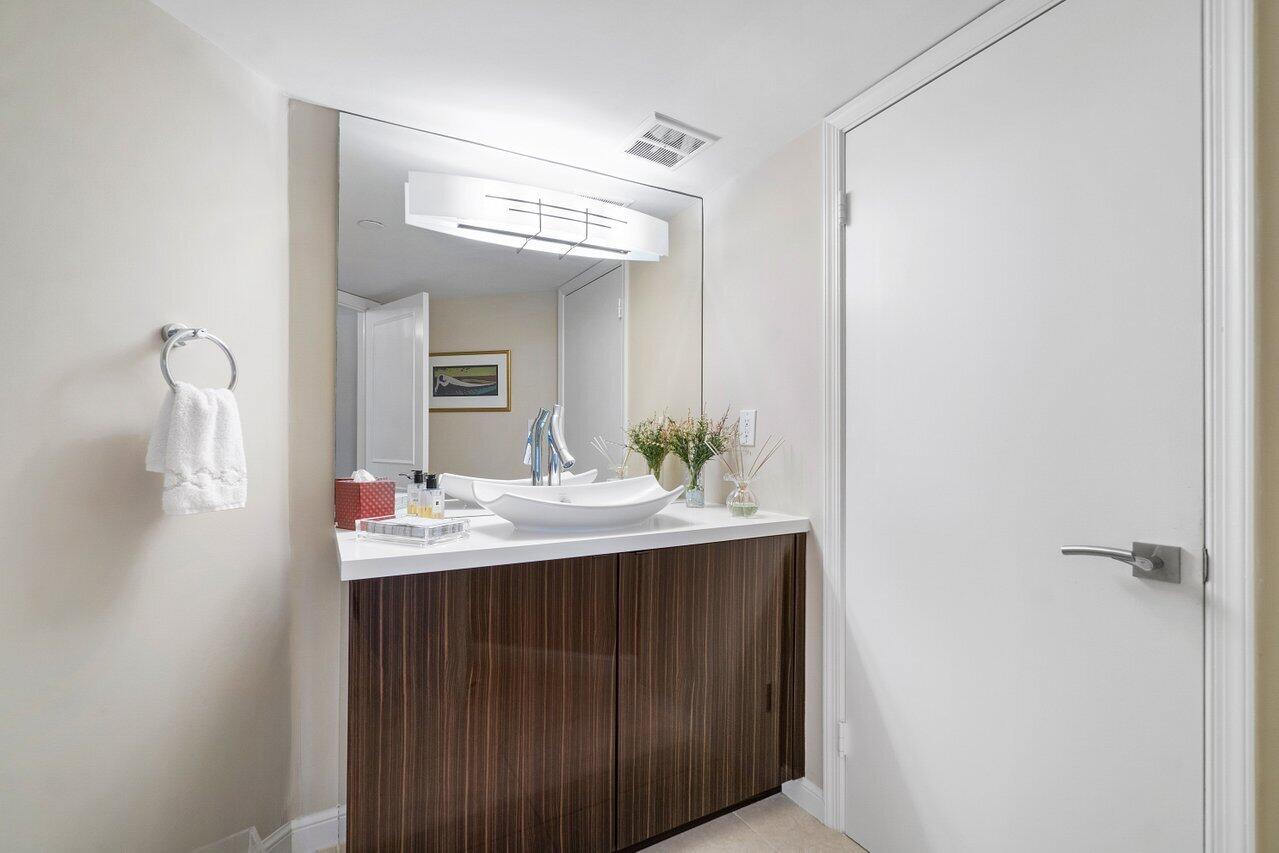 4545 North Ocean Boulevard, Unit 11C Boca Raton, FL 33431 - Photo 37 of 58 a bathroom with a sink and a mirror