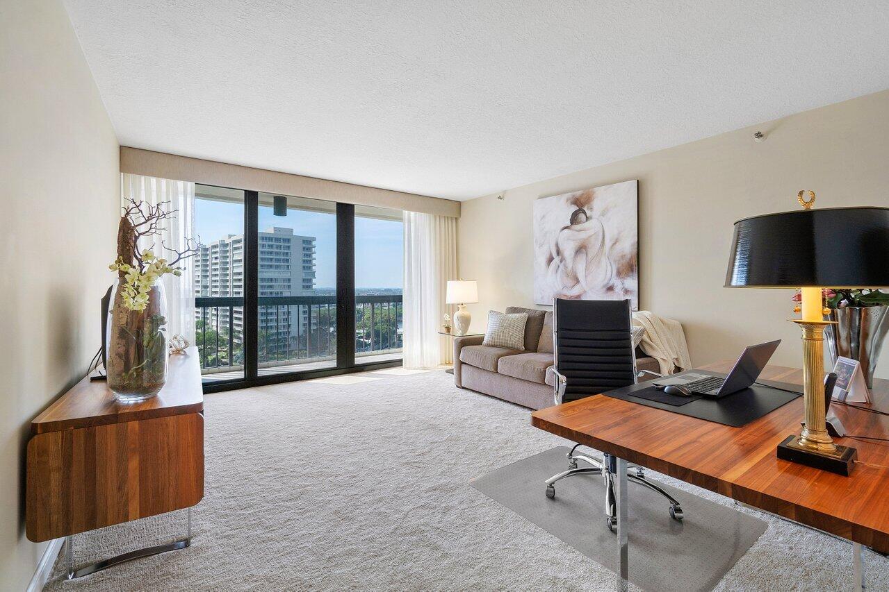 4545 North Ocean Boulevard, Unit 11C Boca Raton, FL 33431 - Photo 38 of 58 a living room with furniture a flat screen tv and a floor to ceiling window