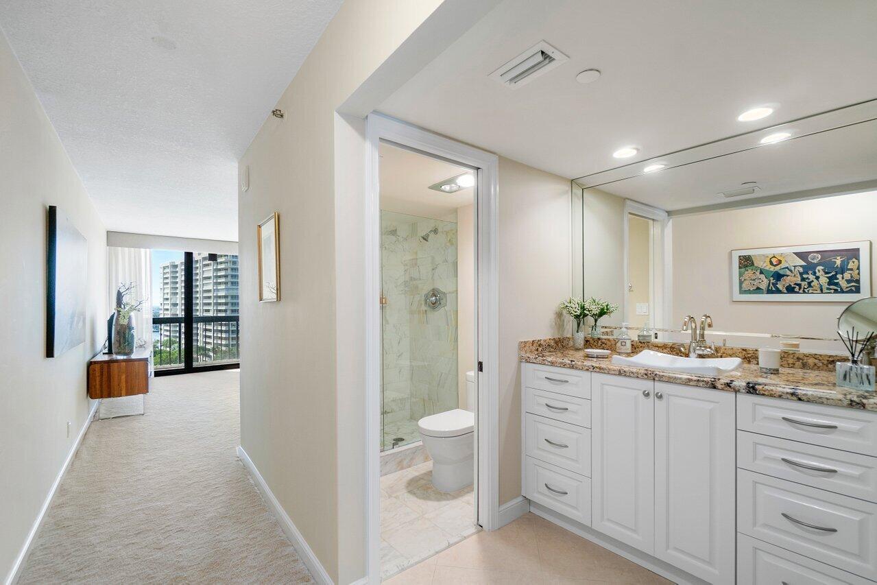 4545 North Ocean Boulevard, Unit 11C Boca Raton, FL 33431 - Photo 43 of 58 a bathroom with a double vanity sink toilet and shower