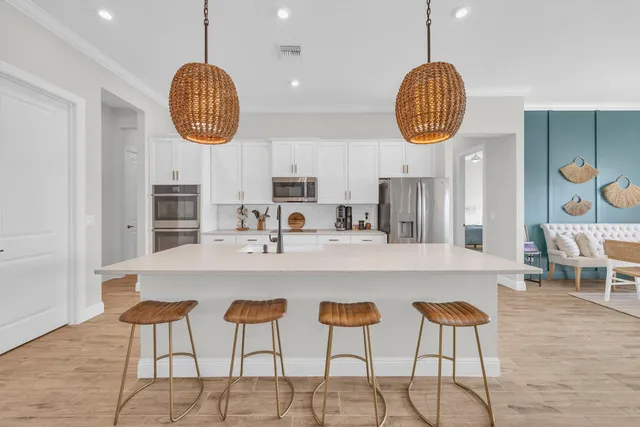 a kitchen with dining table and chairs