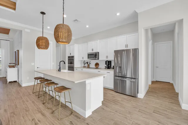 a kitchen with refrigerator cabinets and a table