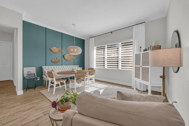 a living room with furniture a window and a dining table