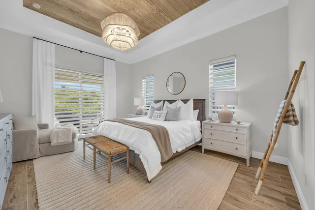 a bedroom with furniture and a chandelier